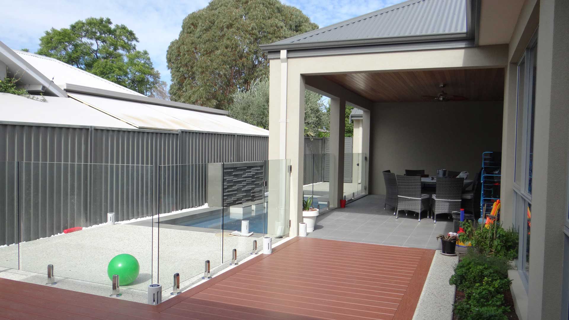Frameless flass pool fencing around a pool area
