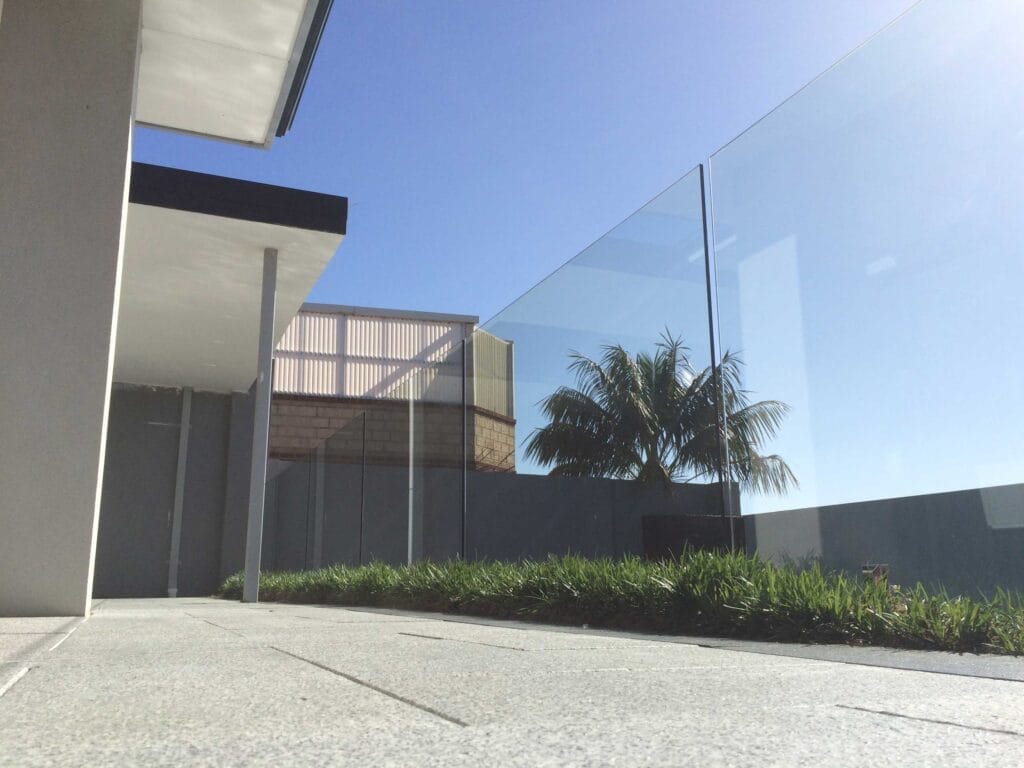 Frameless glass pool fencing around a pool area