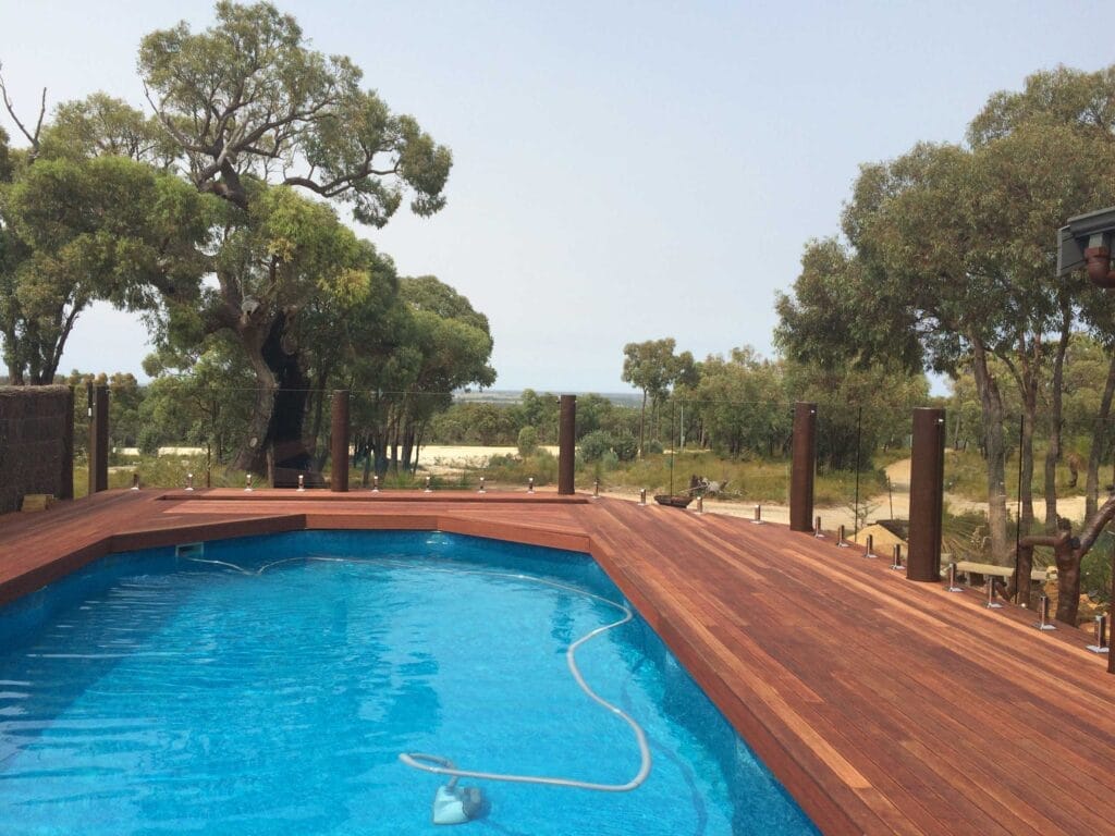 Frameless glass pool fencing around a pool area
