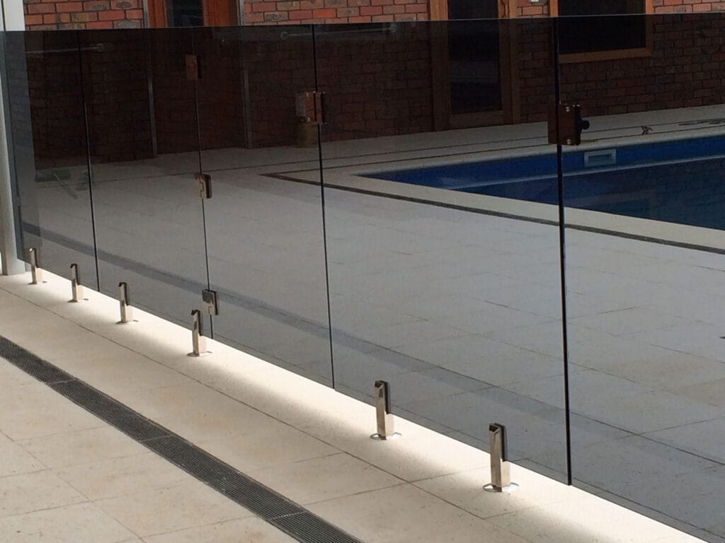 Frameless glass pool fencing around a pool area
