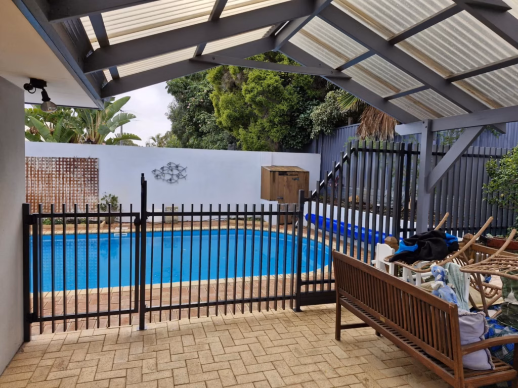 Black slimline batten fencing around a circular blue pool