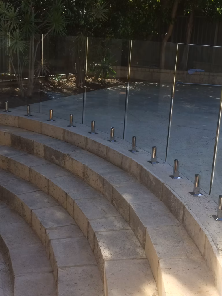 Frameless glass fencing encircling limestone steps down