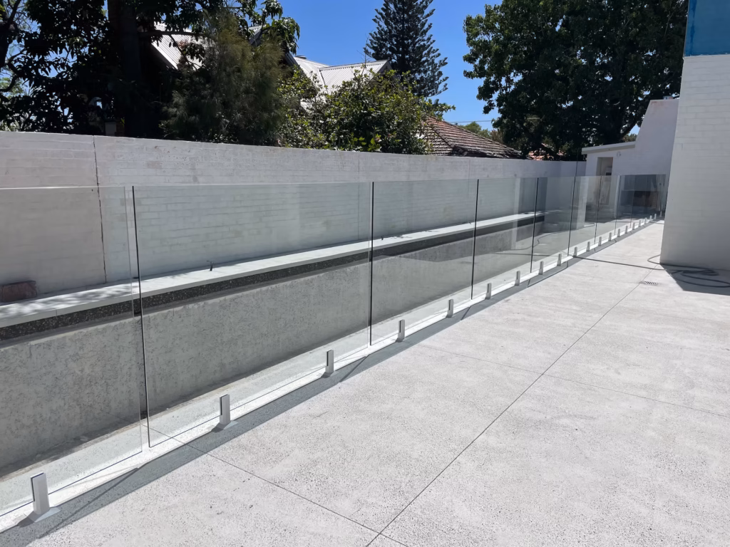 frameless glass fence on white concrete flooring
