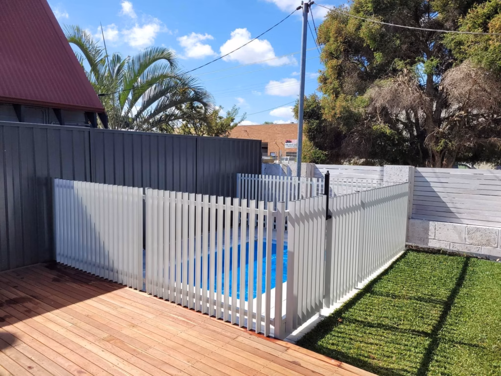 White blade fencing surrounding a pool