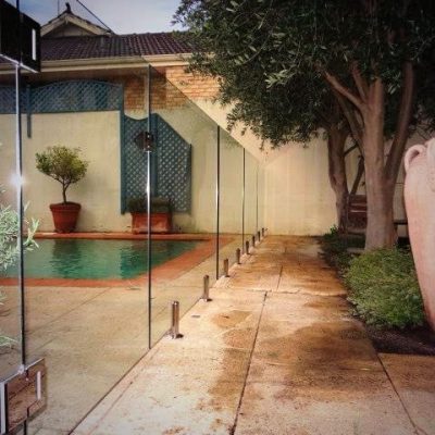 Frameless glass pool fencing around a pool area