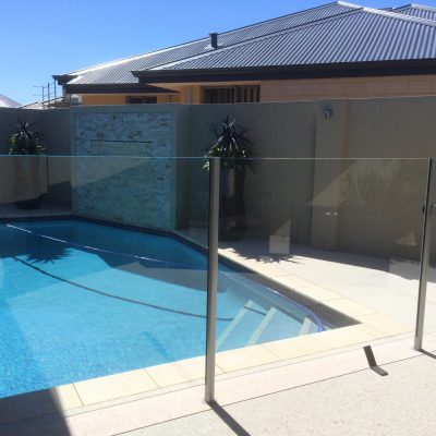 Semi frameless glass pool fence around pool area