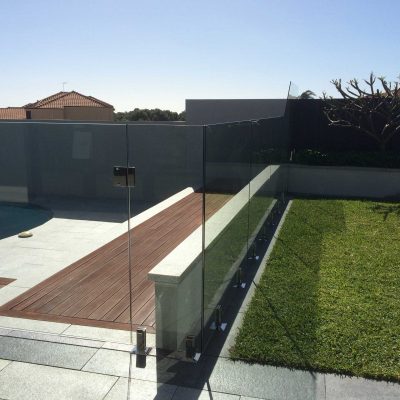 Frameless glass pool fencing around a pool area