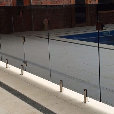 Frameless glass pool fencing around a pool area